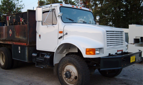Repair of the flatbed's cab and front end included a new bumper, and hood.