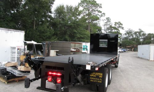 Rear view of truck shows the piggyback forklift mount.