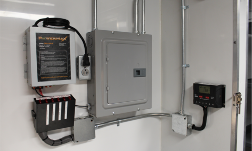 Electrical panels managing the trailer's 120v and 12v power systems, including a roof-mounted solar battery charger.
