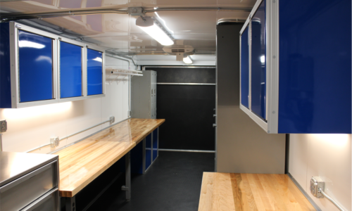 USCG trailer interior, rear view showing desks, crew lockers and blue CTECH cabinets for storage.