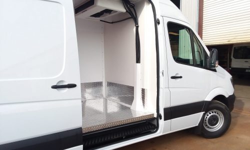 Cargo door view with ceiling mounted Thermo King refrigeration unit.