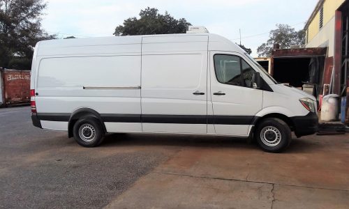 Mercedes Benz refrigerated van with Thermo King unit, curbside view.