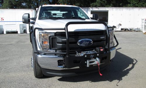 Ford F550 flatbed build included a grill guard and heavy duty Warn winch.